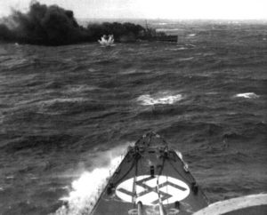 Under crushing fire from Admiral Hipper's guns, HMS Glowworm is making a smokescreen to try & get close enough to fire torpedoes- but all miss the German cruiser. 