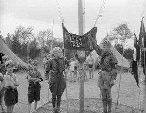 American Fascist meeting in New Jersey ends with a Ku Klux Klan wedding under a burning cross- hassled by locals loudly singing the "Star Spangled Banner" outside. The pro-Fascist "Americanism" rally is being held at Camp Nordland, the Bund's Nazi summer camp, rented by the Klan. ~1000 anti-fascist protesters outside.
