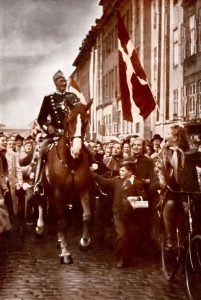 Today is King Christian of Denmark's birthday; he's taking his daily horse ride as usual, conspicuously ignoring the salutes of German soldiers occupying his country. With Danish dissent to the German occupation banned, King Christian's insignia have become a symbol of quiet opposition to the Nazis