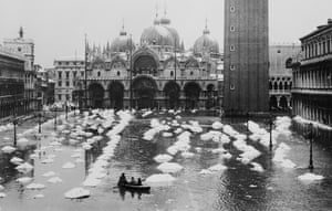 December 1933. Piazza San Marco, which sits just above sea level, is quick to flood during acqua alta when water surges up through the drains in the square. In this case, thawing snow created a flood in front of St Mark’s basilica.Photograph: Bettmann/Corbis
