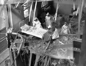 London still counting the cost of last week's huge air raid; nurses in St. Peter's Hospital, Stepney clear a bombed ward