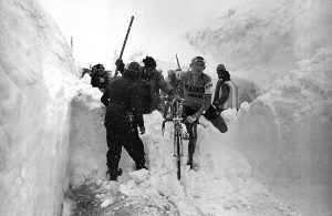 The Italian cyclist Aldo Moser carrying his bicycle over a pile of snow during the 20th stage of the Giro d'Italia Madesimo-Stelvio. 