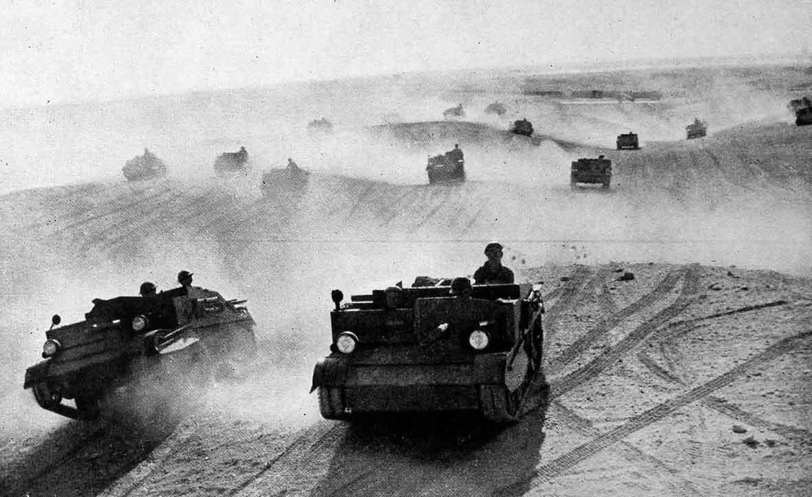 In Egypt, 30,000 British & Commonwealth troops are advancing deep into the desert- ready for a surprise attack on Italian invaders. Allied forces hiding in no-man's land of the Egyptian desert; windscreens removed from vehicles so no Italian reconnaissance will spot tell-tale sun-glare