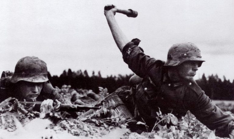 German Soldier Throws Stick Grenade. Deutsche Heer Obergefreiter (German Army Senior Lance-Corporal) prepares to throw a Model 24 Stielhandgranate (Stick Hand Grenade) ww2