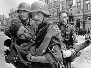 Three German soldiers help a wounded comrade to safety during the Battle of Rostov-on-Don, 1942