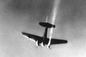 A German bomber, with its starboard engine on fire, goes down over an unknown location, during World War II, in November, 1941.