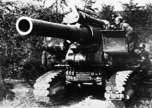 A huge Russian gun on tracks, likely a 203 mm howitzer M1931, is manned by its crew in a well-concealed position on the Russian front on September 15, 1941.