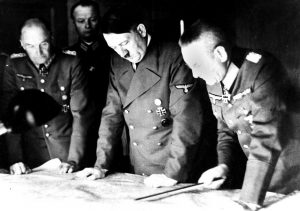 Adolf Hitler, center, studies a Russian war map with General Field Marshal Walter Von Brauchitsch, left, German commander in chief, and Chief of Staff Col. General Franz Halder, on August 7, 1941.