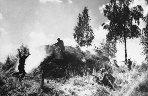 Finnish soldiers storm a soviet bunker on August 10, 1941. One of the Soviet bunker’s crew surrenders, left.