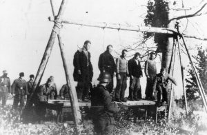 Five Soviet civilians on a platform, with nooses around their necks, about to be hanged by German soldiers, near the town of Velizh in the Smolensk region, in September of 1941.