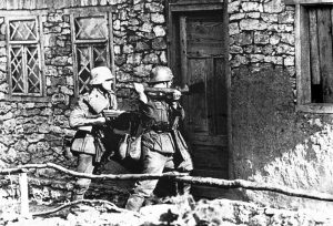 German infantrymen force their way into a snipers hide-out, where Russians had been firing upon advancing German troops, on September 1, 1941.