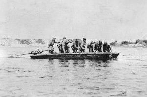 German soldiers cross a river, identified as the Don river, in a stormboat, sometime in 1941, during the German invasion of the Caucasus region in the Soviet Union.