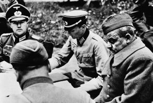 German sources described the gloomy looking officer at the right as a captured Russian colonel who is being interrogated by Nazi officers on October 24, 1941.