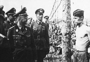 Heinrich Himmler (left, in glasses), head of the Gestapo and the Waffen-SS, inspects a prisoner-of-war camp in this from 1940-41 in Russia.